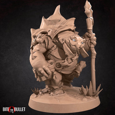 Anthropomorphic turtle with a kindly expression, holding a staff. Resin miniature by Bite the Bullet.