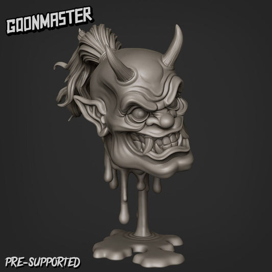 Resin miniature by Goon Master. Oni head with horns and tusks, supported by blood dripping into a puddle.