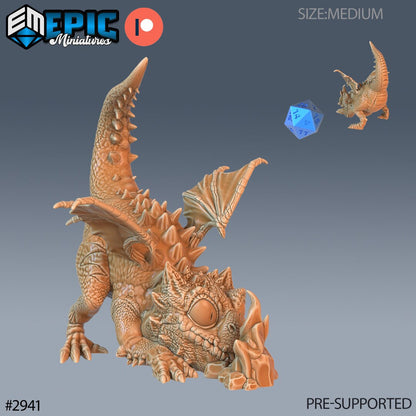 Resin miniatures by Epic Miniatures. Baby dragon option #2: curious hatchling examining stone.