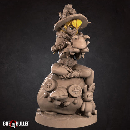 Christmas elf girl sitting on a toy snowman head, holding a toy that's sticking its tongue out at her. Resin miniature by Bite the Bullet.