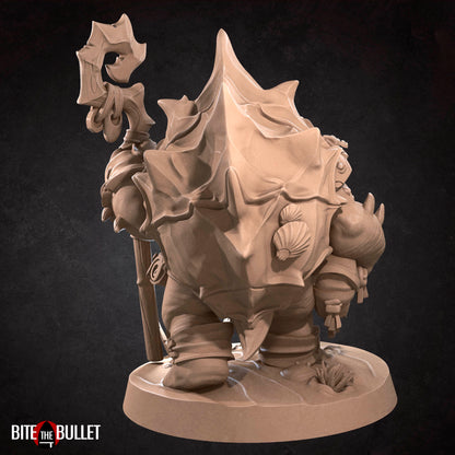 Anthropomorphic turtle with a kindly expression, holding a staff. Resin miniature by Bite the Bullet.