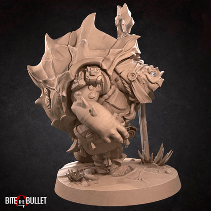 Anthropomorphic turtle with a kindly expression, holding a staff. Resin miniature by Bite the Bullet.