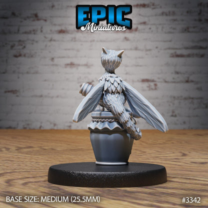 Resin Bee-Dragon Wyrmling miniature by Epic Miniatures. Version #1 rear view: perched on a jar of honey, clutching a honey dipper.