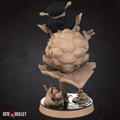 Kappa (anthropomorphic turtle) sitting on a lily pad, eating ramen. Resin miniature by Bite the Bullet.