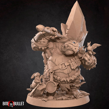 Anthropomorphic turtle barbarian with a huge rock axe on his shoulder, looking kindly at a bird perched on his finger. Resin miniature by Bite the Bullet.